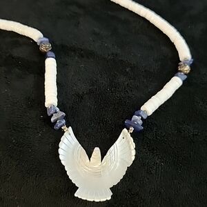 Mother of pearl necklace with a carved Eagle pendant.
